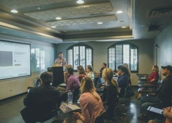 a group of people in a room with a projector screen