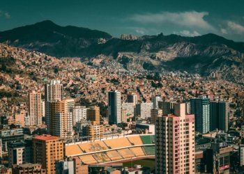A stunning aerial view of La Paz, Bolivia with a backdrop of mountains and urban architecture.