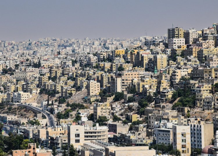 Aerial view of Amman, Jordan showcasing dense urban architecture and vibrant city life.
