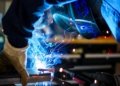 man holding gray steel frame