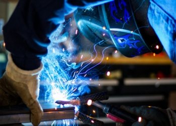 man holding gray steel frame