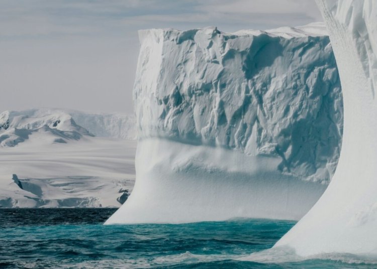 a large iceberg floating in the middle of the ocean