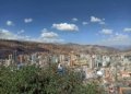 a view of a city with mountains in the background