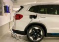 an electric car plugged in to a charging station