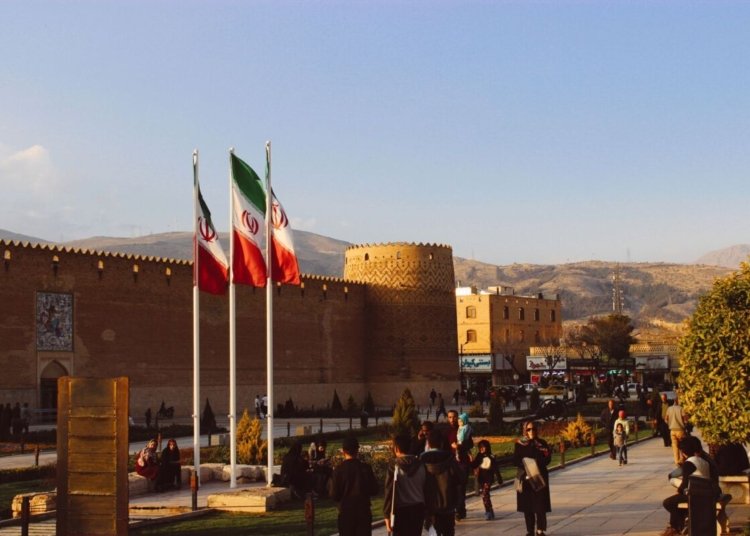 Karim Khan Citadel with Iranian flags in Shiraz, Iran at sunset.