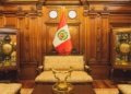 Stylish interior in Lima featuring ornate furniture and the Peruvian flag.