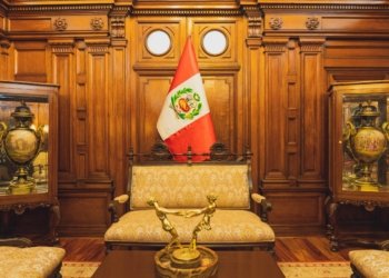 Stylish interior in Lima featuring ornate furniture and the Peruvian flag.