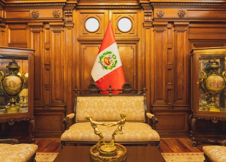 Stylish interior in Lima featuring ornate furniture and the Peruvian flag.