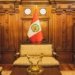 Stylish interior in Lima featuring ornate furniture and the Peruvian flag.