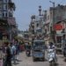 Vibrant street life in Delhi with shops, vehicles, and people capturing the city's energy.