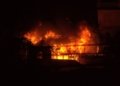 a fire blazing in a building at night