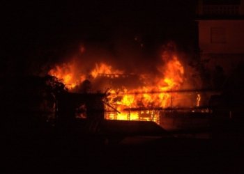 a fire blazing in a building at night