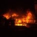 a fire blazing in a building at night