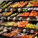 Colorful assortment of fresh fruits neatly arranged on supermarket shelves, ideal for healthy eating themes.