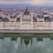 Scenic aerial shot of the Hungarian Parliament Building reflecting on the Danube River in Budapest.