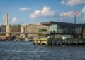 Scenic waterfront view of Washington DC featuring the Washington Monument and modern architecture.