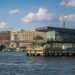 Scenic waterfront view of Washington DC featuring the Washington Monument and modern architecture.