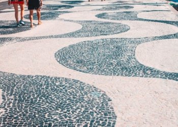 2 women walking on white and blue round concrete floor during daytime