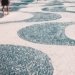 2 women walking on white and blue round concrete floor during daytime