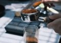 a person is grinding coffee beans in a coffee grinder