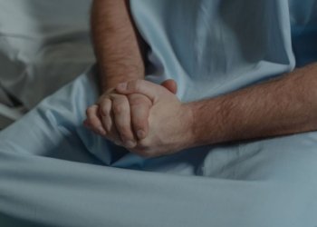 patient with his hands together