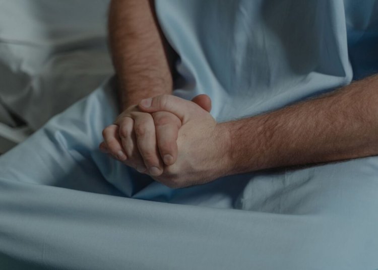 patient with his hands together