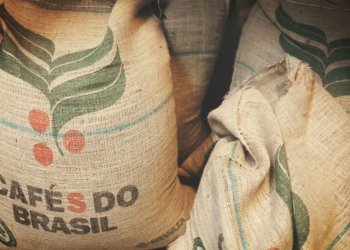 two bags of coffee beans sitting next to each other