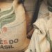two bags of coffee beans sitting next to each other
