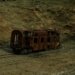 A decaying train car sits isolated in a São Paulo grassland, symbolizing neglect and history.