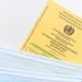 An international vaccination certificate with face masks on a white surface symbolizing health safety.