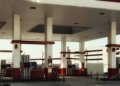 Brightly lit modern gas station featuring multiple fuel pumps and a distinct red and white design.