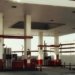 Brightly lit modern gas station featuring multiple fuel pumps and a distinct red and white design.
