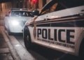 Close-up of Royal Newfoundland Constabulary police cars parked on a street at night.