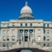 Front view of the historic Idaho State Capitol Building under blue skies in Boise.